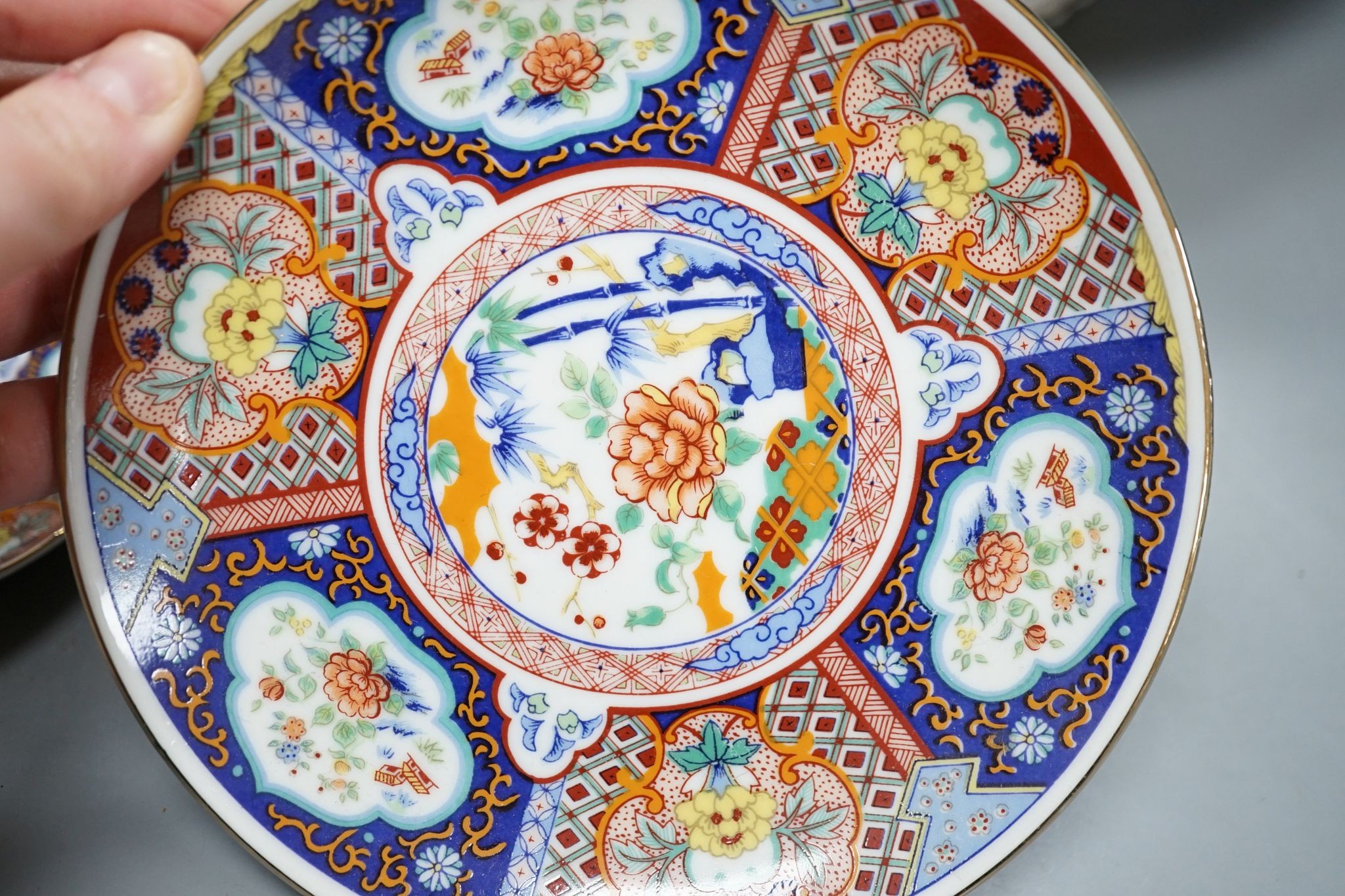 A Royal Crown Derby Imari bowl and two plates and another bowl, 25cm